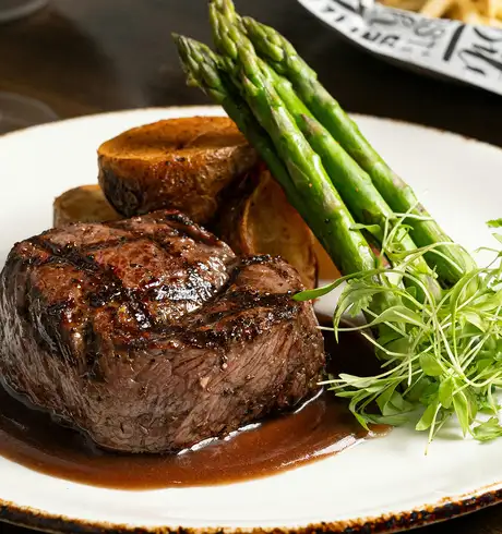A fancy meal consisting of, Steak, Potatoes and Asparagus