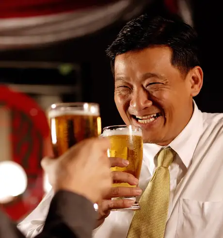 Two friends drinking beer in a bar