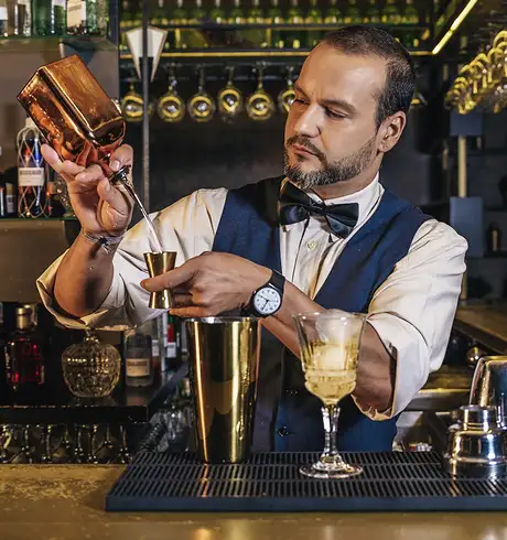 A bartender making a drink