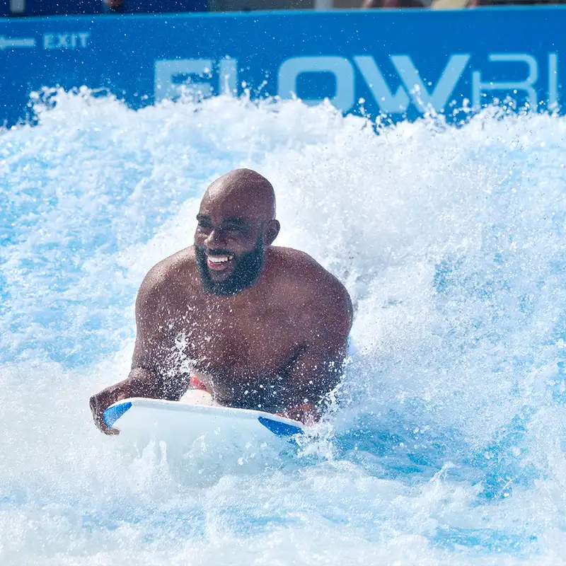 A man riding the FlowRider aboard a Royal Caribbean Ship