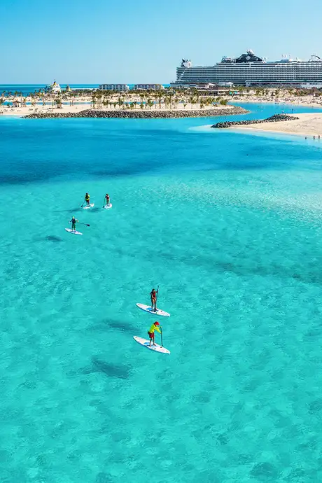 An Aerial view of Lagoon Beach with a paddle board tour taking place in the water