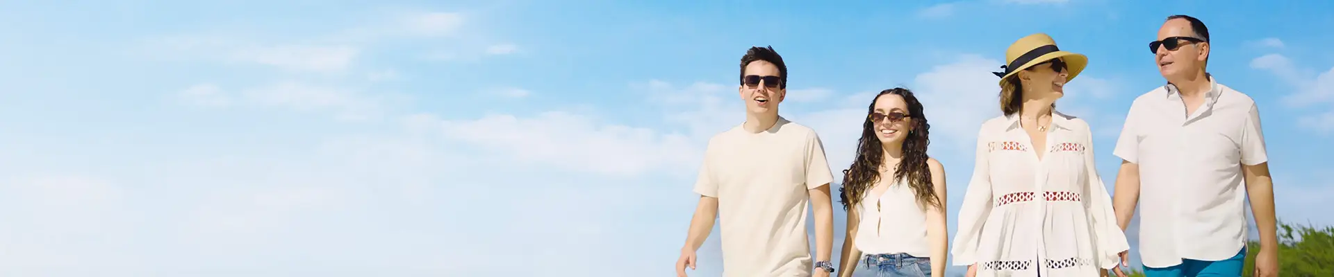 A family walking down the shore of Half Moon Cay