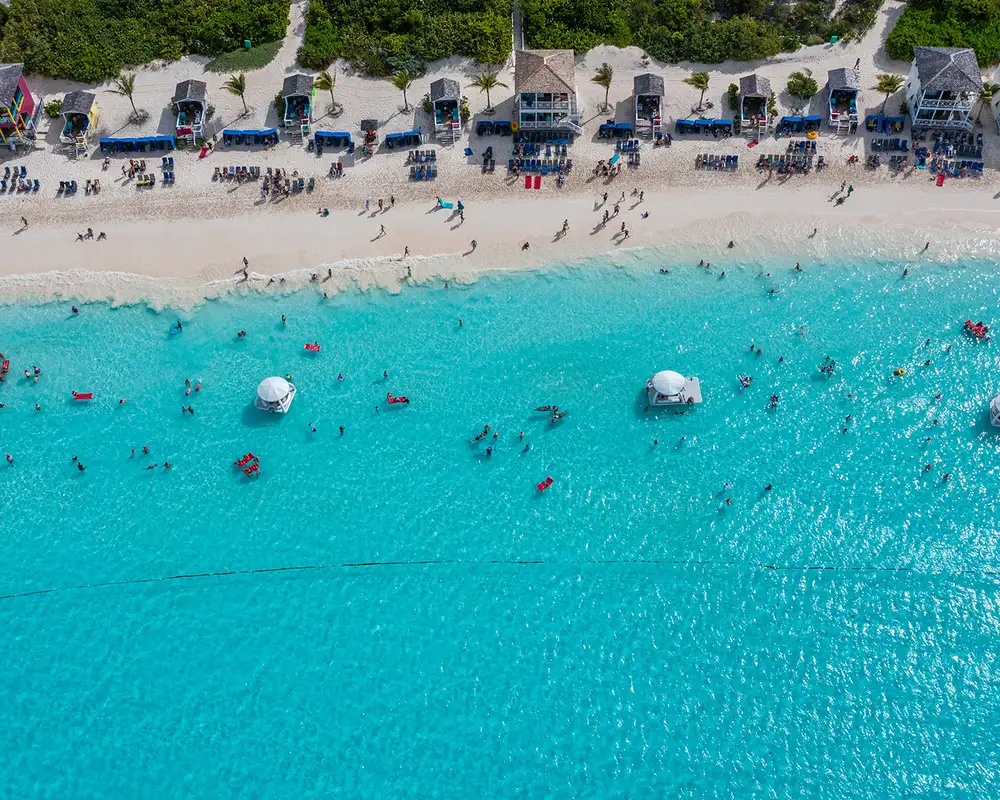 An Aerial image of the beach of Half Moon Cay filled with people