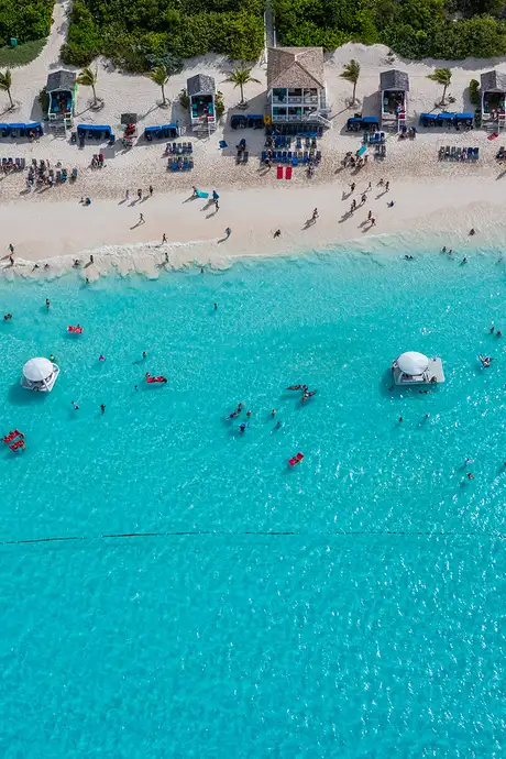 An Aerial image of the beach of Half Moon Cay filled with people