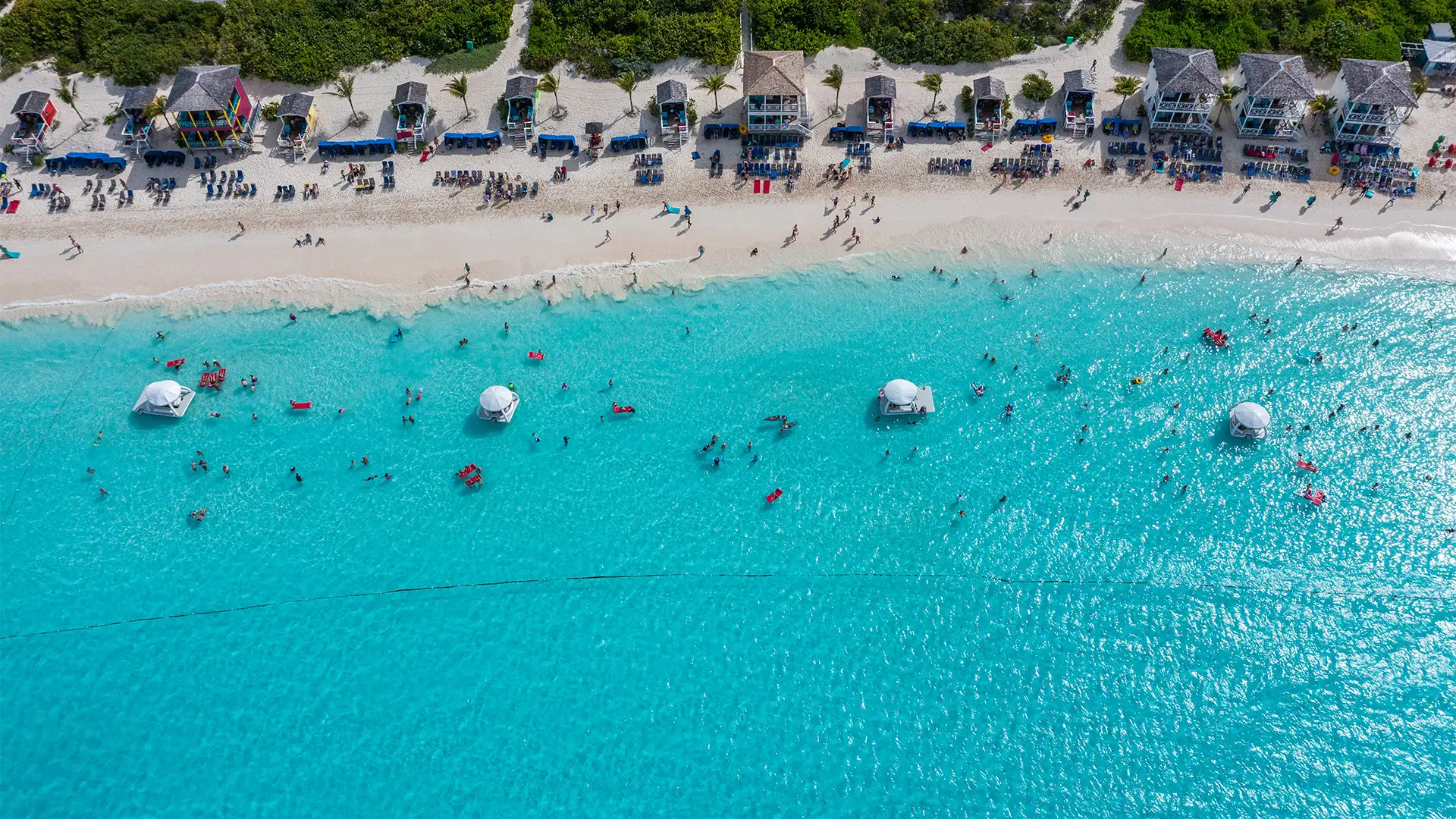 An Aerial image of the beach of Half Moon Cay filled with people