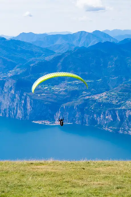 A Paraglider gliding over Lake Garda, Italy