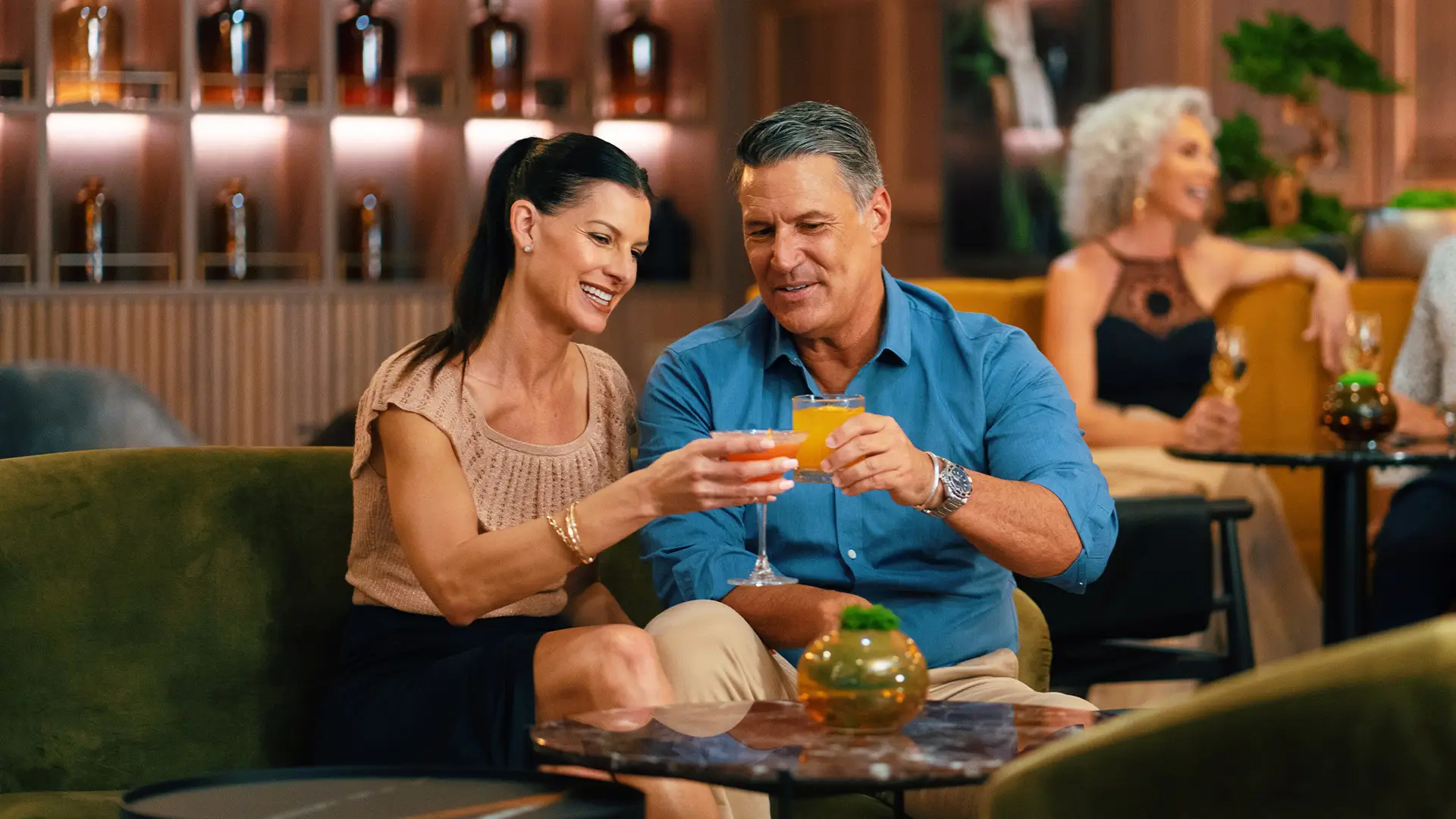 A Couple enjoying drinks in a bar aboard an Azamara Ship