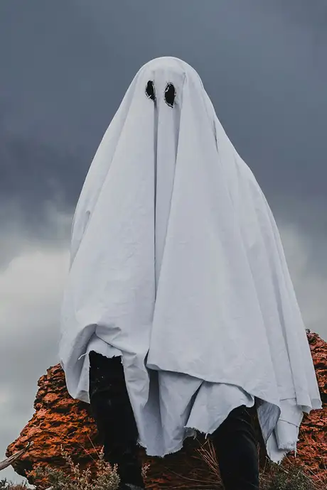 A man wearing a ghost costume