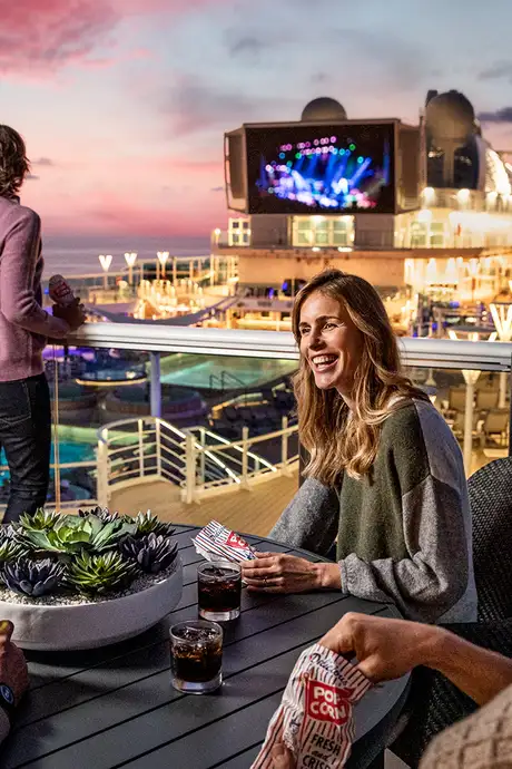 People watching a movie on a large screen on a Princess Ship