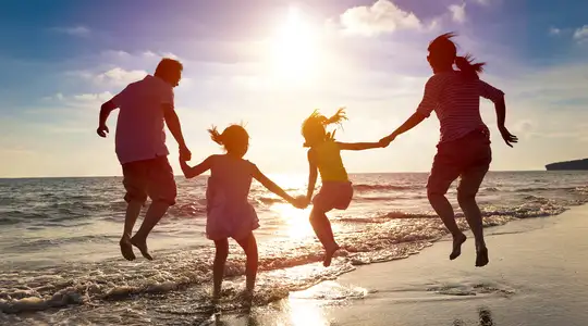 A Family at the beach at sunset