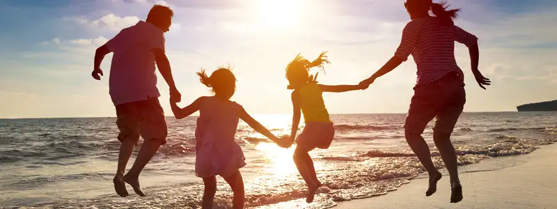 A Family at the beach at sunset