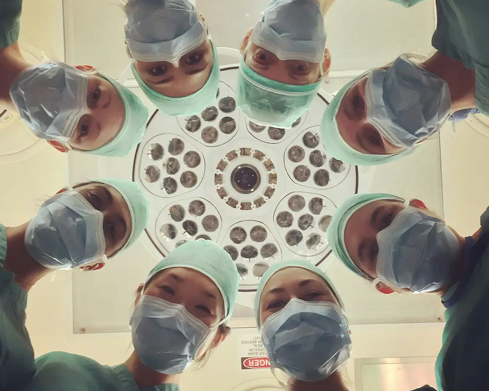A Group of Doctors and Nurses looking down at the camera