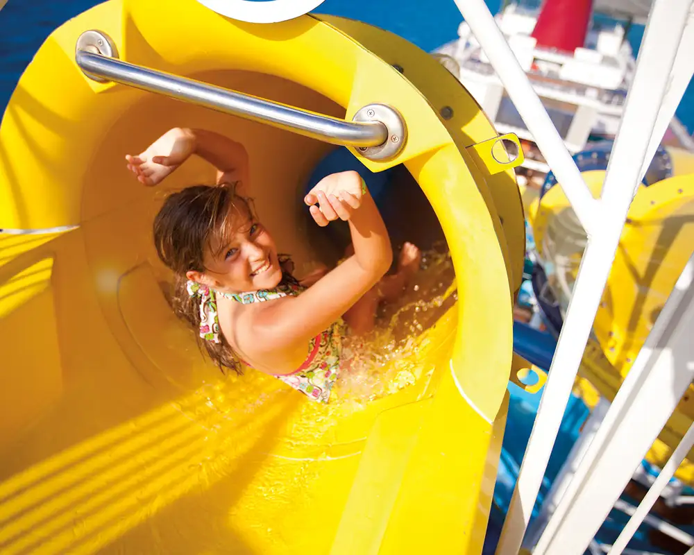 A Girl going down a water slide aboard a Carnival Cruise Ship
