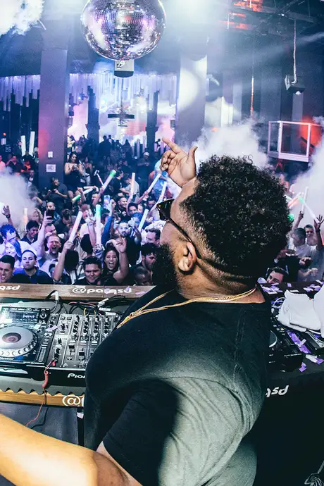 A DJ performing in a nightclub