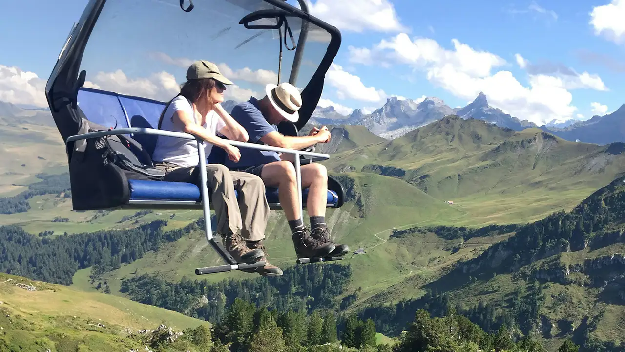 A Couple riding a cable car through mountains