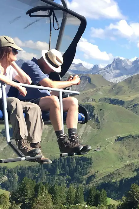 A Couple riding a cable car through mountains