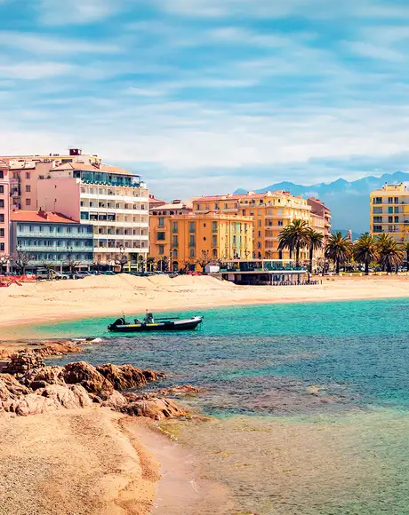 An image of colourful houses on the shore of a Mediterranean City