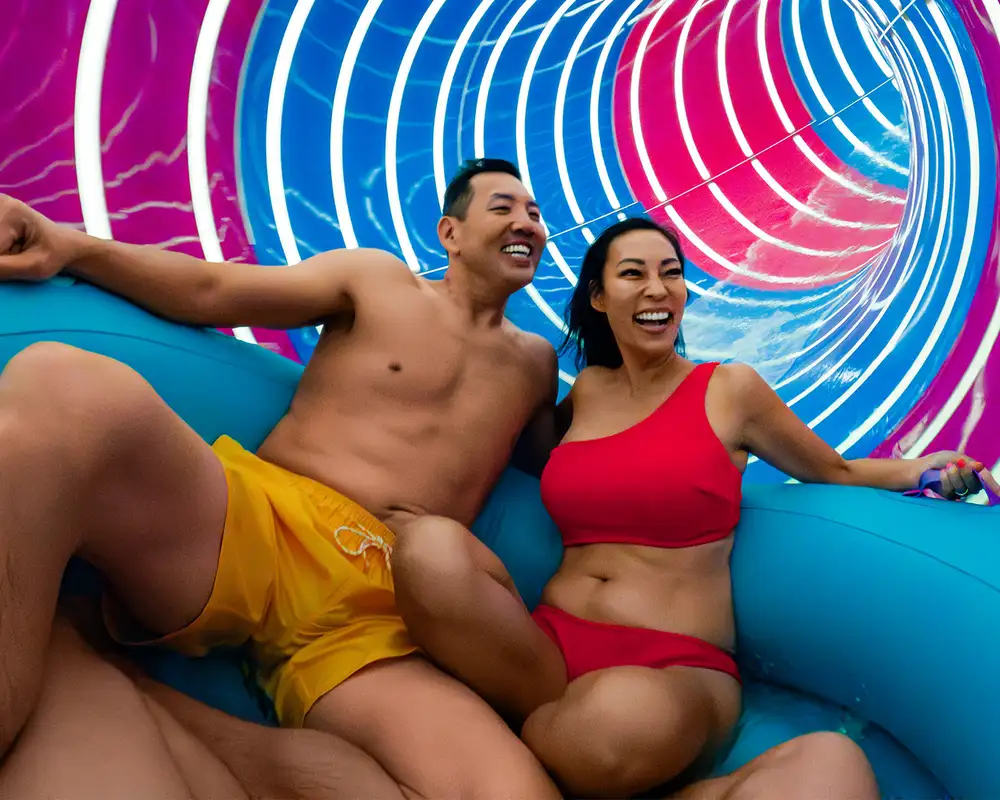 A Couple riding the Supercell waterslide onboard a Royal Caribbean ship
