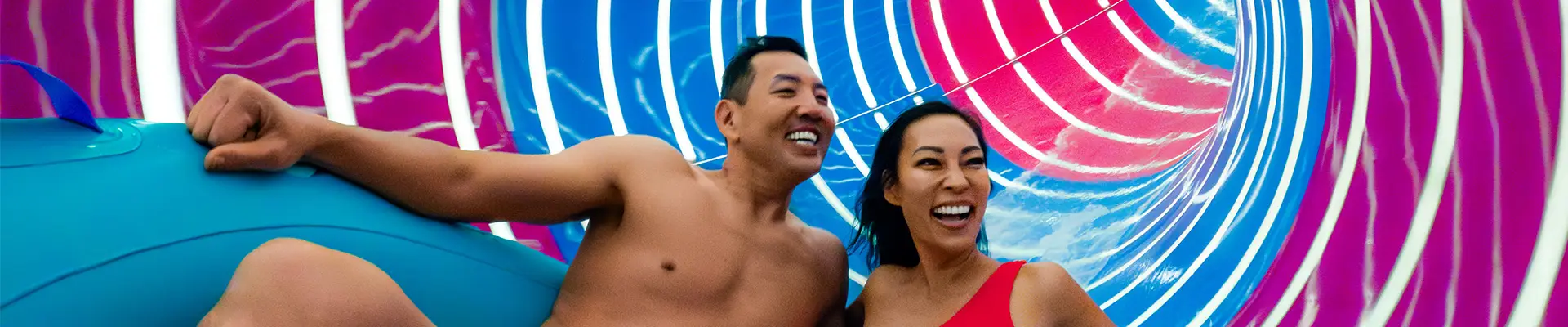 A Couple riding the Supercell waterslide onboard a Royal Caribbean ship