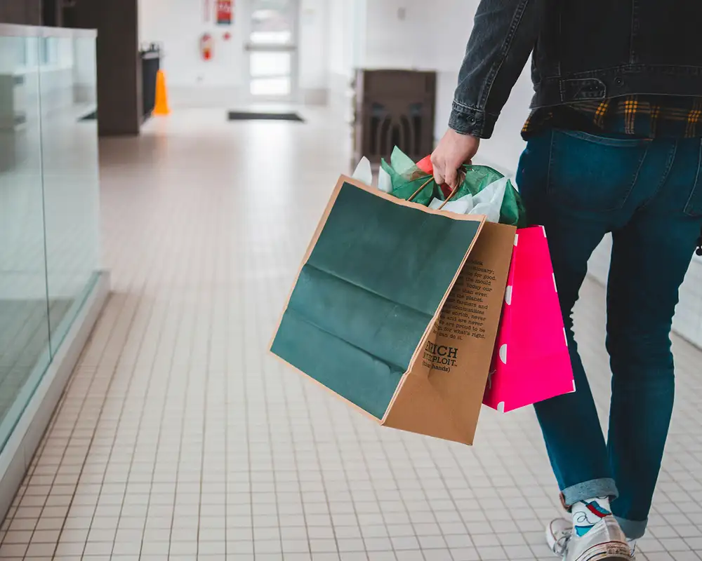 A man walking with shopping bags