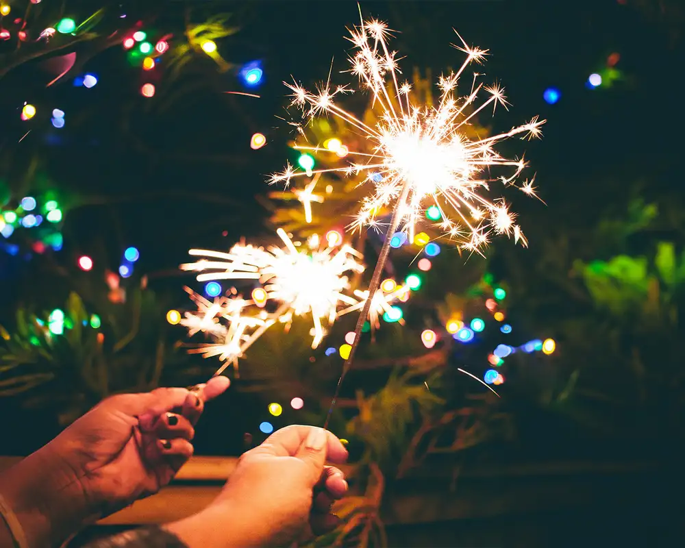 Two people holding sparklers