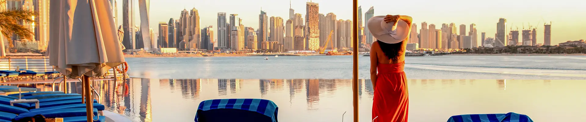 A woman relaxing by a pool during a sunset