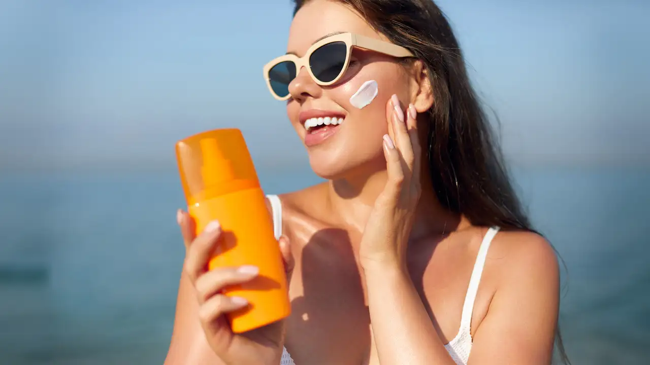 A woman applying sunscreen