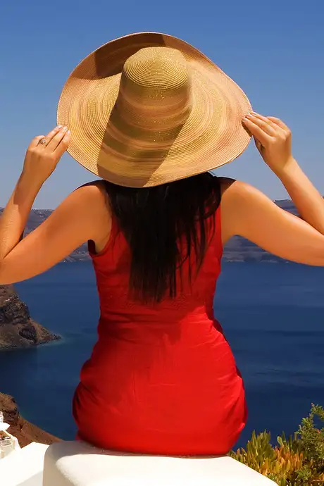 A Woman looking out over the coast of Santorini