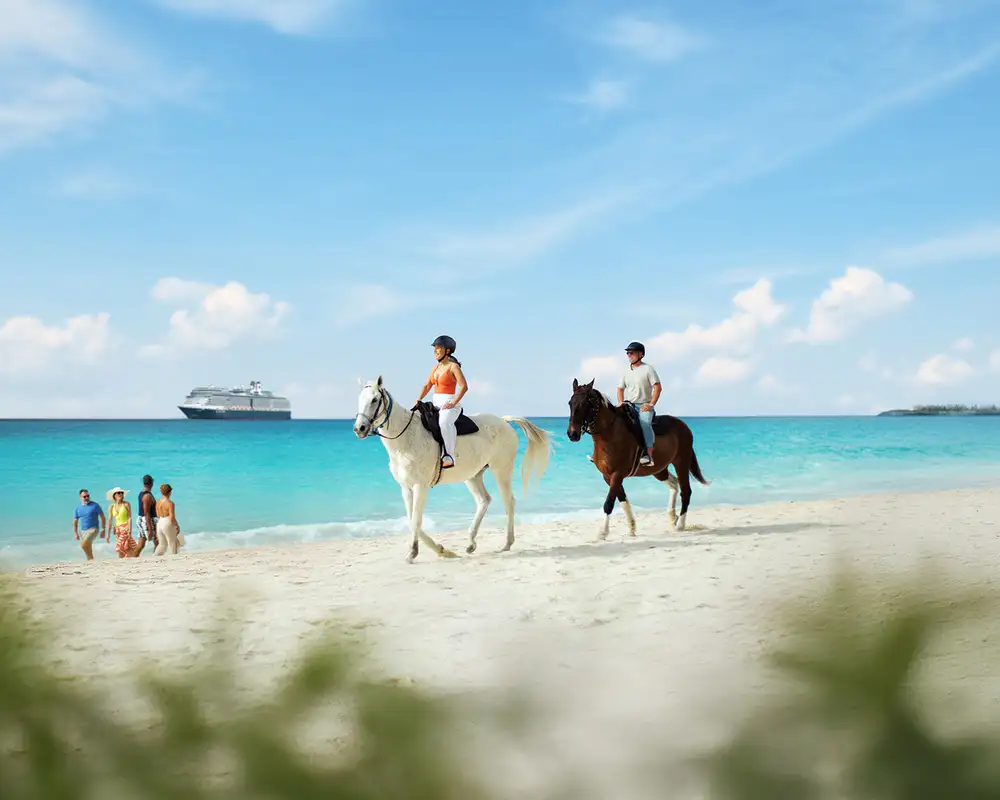A View of people riding on horseback down the beach on Half Moon Cay