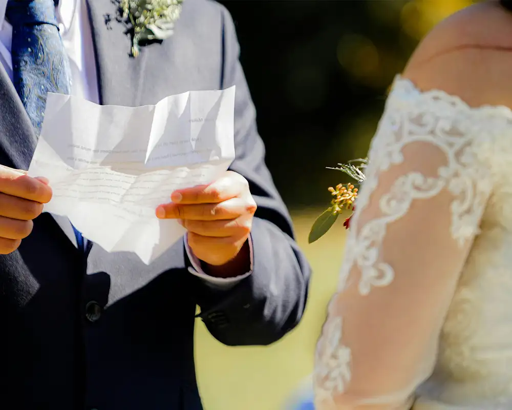 A Couple on their wedding day reading their vows