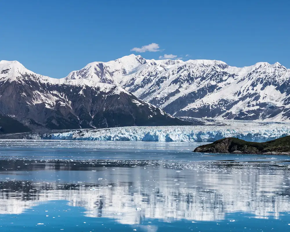 A Glacier in Alaska with snowy mountains in the background