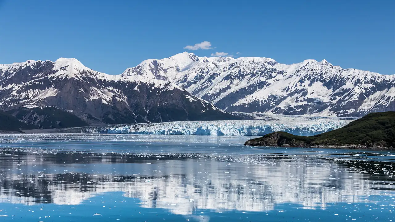 A Glacier in Alaska with snowy mountains in the background