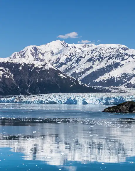 A Glacier in Alaska with snowy mountains in the background