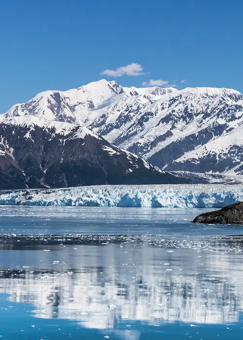 A Glacier in Alaska with snowy mountains in the background