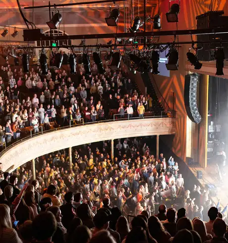 A concert being performed at the Ryman Auditorium in Nashville