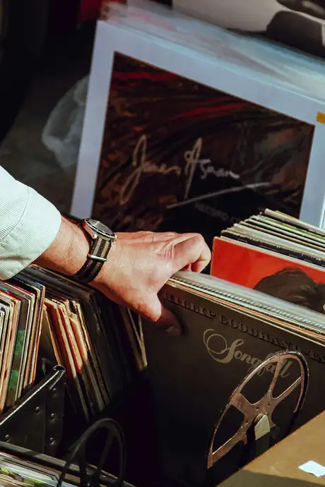 A Man looking through records at a market