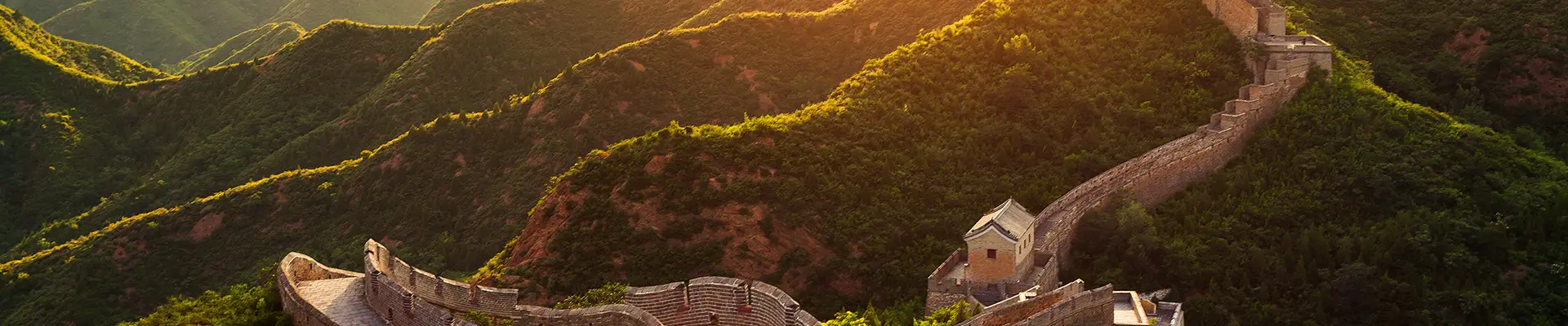 An image of the sun setting over the great wall of china
