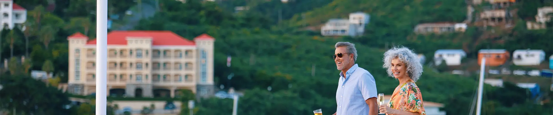 A couple walking on the deck of an Azamara Cruise Ship