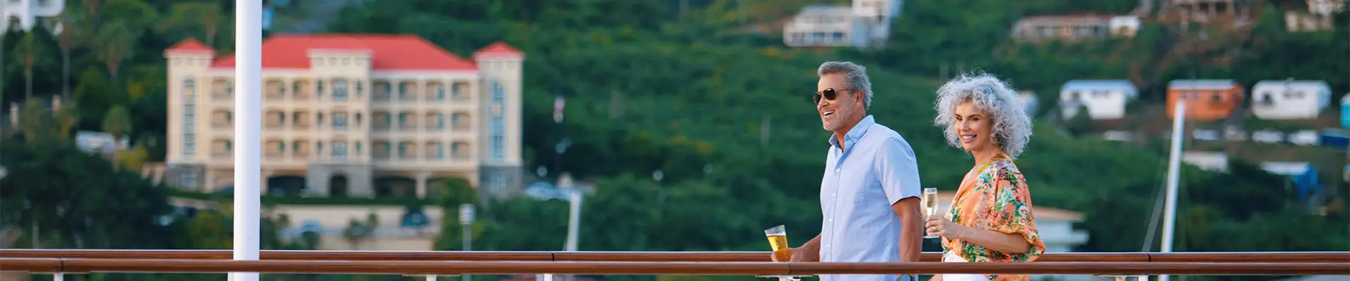 A couple walking on the deck of an Azamara Cruise Ship