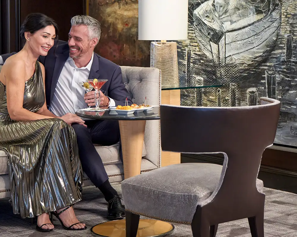 A Couple enjoying drinks in a bar aboard an Oceania Cruise Ship
