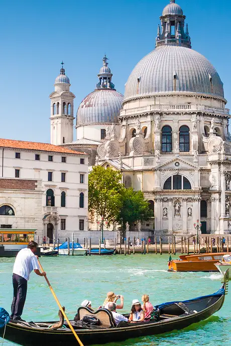 St Mark's Basilica in Venice, Italy with a gondola going down a canal infront