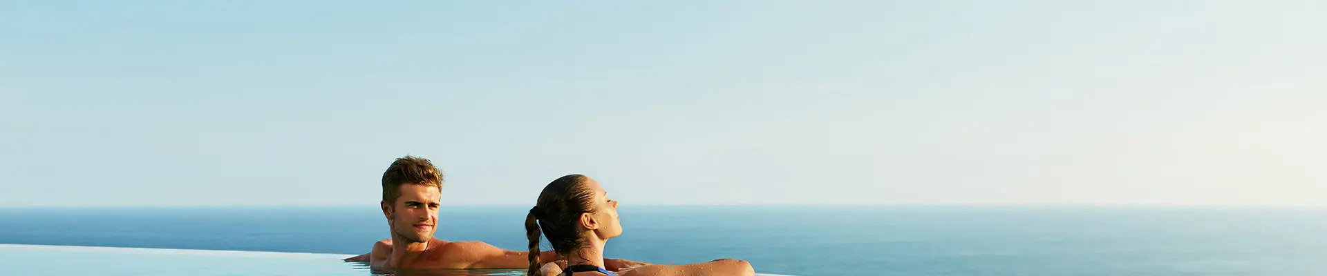 A Couple in a pool looking out over the ocean