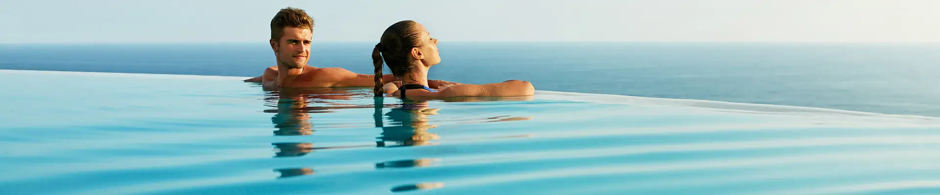 A Couple in a pool looking out over the ocean