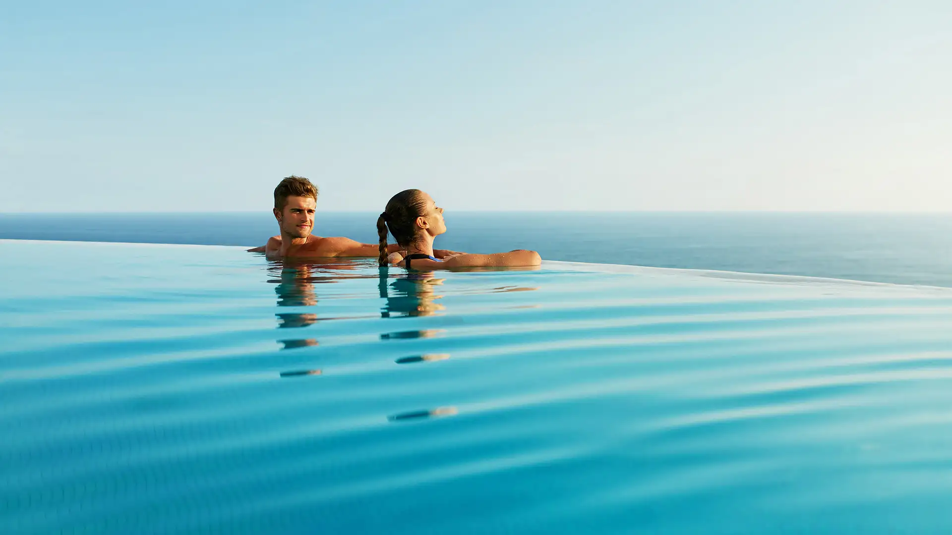 A Couple in a pool looking out over the ocean