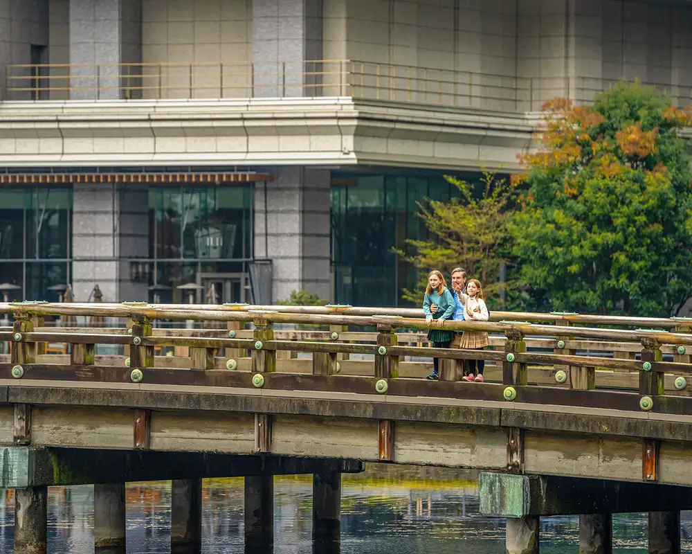 A Family standing on a bridge in Japan
