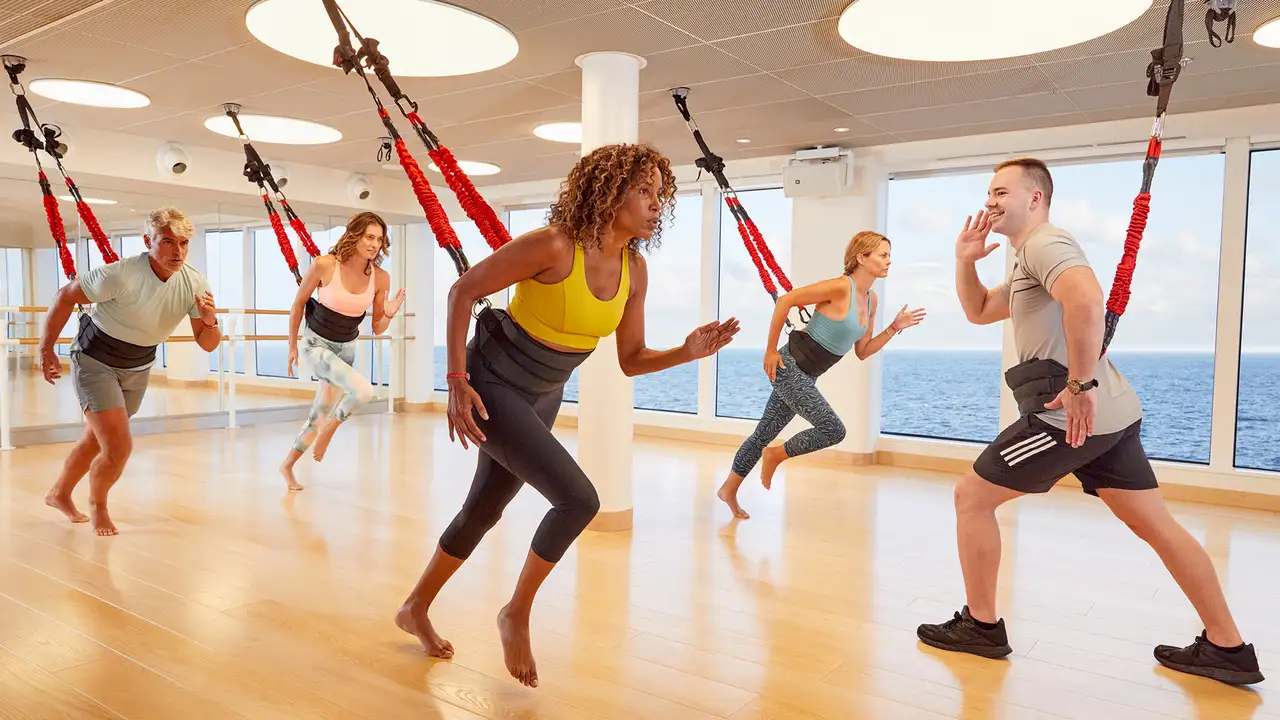 A group of people taking part in a Fitness Class aboard a Virgin Voyages Ship