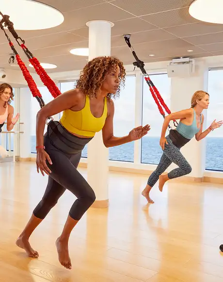 A group of people taking part in a Fitness Class aboard a Virgin Voyages Ship
