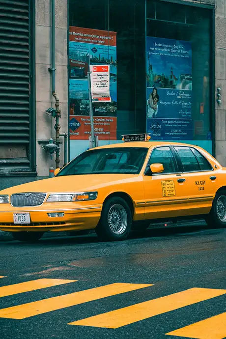 A Taxi Parked on the side of a Road