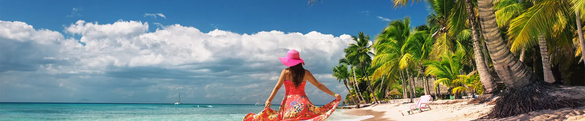 A woman walking down a caribbean beach