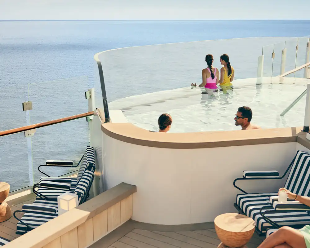 People relaxing in an infinity pool aboard a Celebrity Cruise Ship